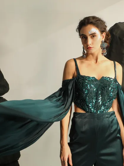 An example of my work in high-fashion and occasion wear. This shot captures the movement and drama of the garment, with a focus on the embellished, off-shoulder top and flowing sleeves, creating an ethereal and powerful look.