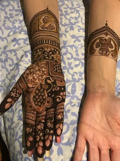 A clear view of the traditional motifs, including the peacock, doli, and a kalash with a swastika, telling a complete wedding story.