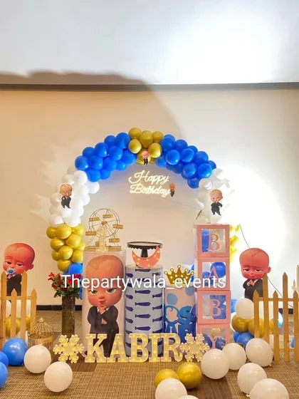 A full view of the Boss Baby setup, showing the balloon arch, character cutouts, and light-up name with a hashtag. I can customize the name and age for any party.