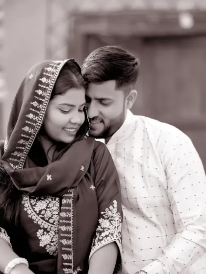 An intimate black and white portrait from the village-themed shoot. The sepia tone gives this photo a vintage feel, perfectly capturing a tender moment between the couple.