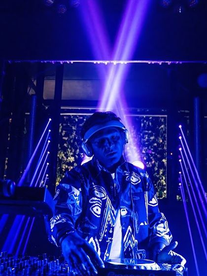 Bathed in blue light, completely focused on the mix. The lighting and visuals are a huge part of the overall sensory experience I aim to create.