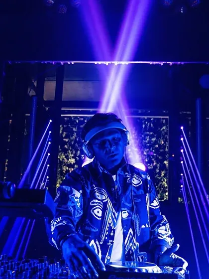 Bathed in blue light, completely focused on the mix. The lighting and visuals are a huge part of the overall sensory experience I aim to create.