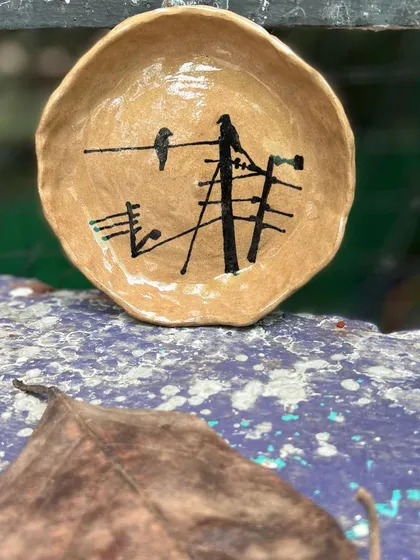 Another take on my crow-on-a-wire theme, this hand-built stoneware plate captures a quiet moment amidst the city's hum. These pieces are my tribute to the resilient nature that thrives everywhere.