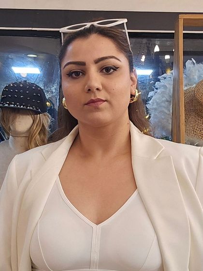 Another angle of my power look. The white sunglasses on my head and the statement gold earrings create a look that's ready for anything, from a business meeting to a stylish day out.