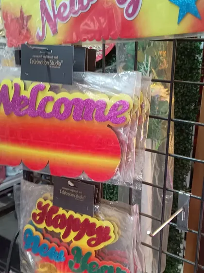 Colorful 'Welcome' and 'Happy New Year' signs. These foam cutouts are a bright and cheerful way to greet your party guests.
