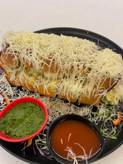 A top-down view of the Italian Sandwich, completely covered in a blanket of grated cheese.
