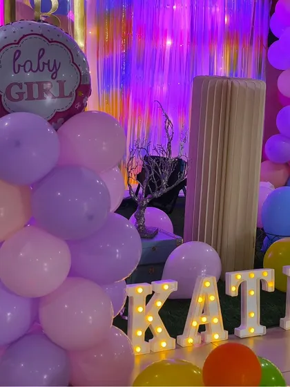 A close-up of the 'Welcome Baby' decor, showing the 'Baby Girl' foil balloon and personalized marquee letters. These details make the celebration extra special for the new parents.