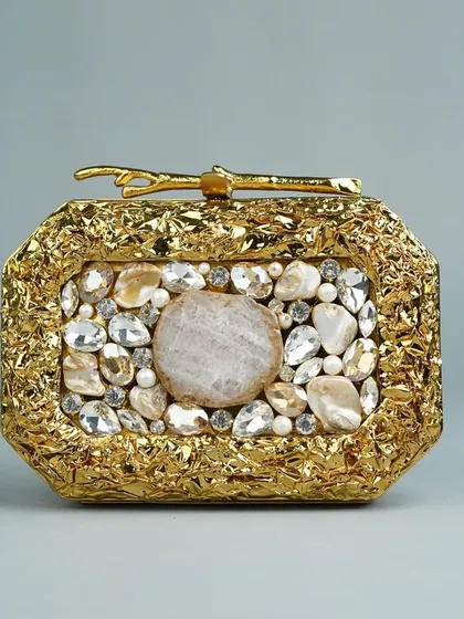 This is one of my most luxurious pieces, a handcrafted brass clutch with a stunning textured gold finish. It's adorned with a beautiful arrangement of natural and polished stones, making it a true statement accessory for any grand occasion.