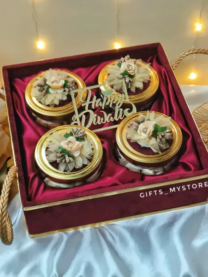 A close-up of our luxurious red velvet box, designed to hold four jars of premium dry fruits. The sturdy, elegant handles make it easy to carry, and the rich texture of the box itself makes a statement.