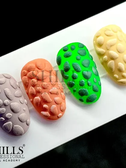 A closer look at the finished stone-effect nails in four different colors, showing the texture and matte finish of this unique design.