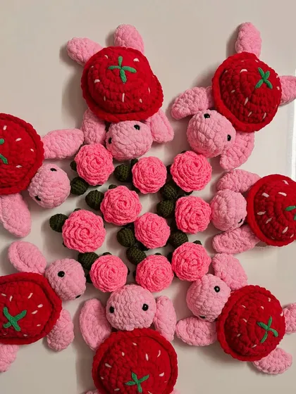 A fun mix of my strawberry and rose turtle plushies. These colorful creations are great for imaginative play or as unique decorative pieces.