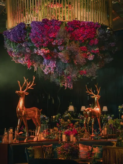 I crafted an enchanted forest for this Sangeet, using deep emerald tones, lush floral installations hanging from the ceiling, and majestic golden deer props to create a truly magical and opulent atmosphere.