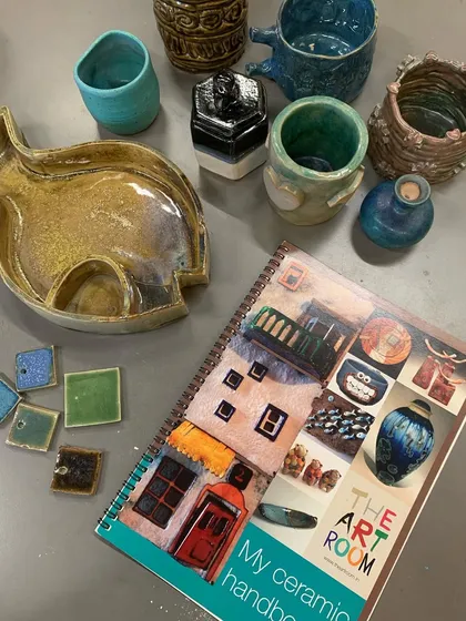 Here is a glimpse of the wonderful things you can create with us. This collection showcases finished student work, including a cat-shaped platter, custom mugs, and decorative tiles, all hand-built and fired in our studio.