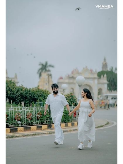 A fun, candid shot of a couple running and laughing in front of the iconic Mysore Palace. We love incorporating famous landmarks into our pre-wedding shoots.