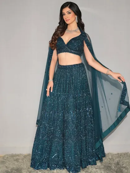 The full-length shot shows off the modern lehenga with a cape, a perfect inspiration for a cocktail or reception outfit.
