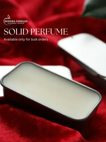 A sleek shot of my solid perfume in a slider tin against a rich red background. This product is available for bulk orders and is perfect for gifting.