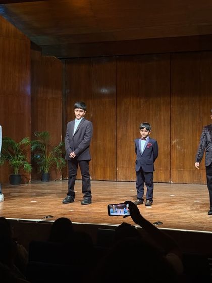 Dressed in sharp suits, these young gentlemen are ready for their formal public speaking presentation.