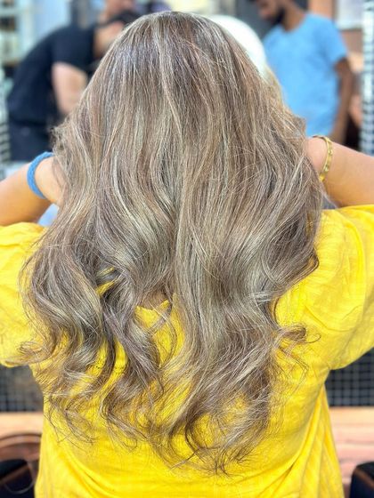 Another angle of the ash blonde highlights, showing how they look with soft waves. Styling can really bring out the dimension created by the color.
