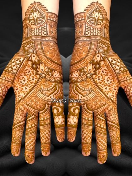 A stunningly detailed design with a heart motif at the wrist, perfect for an engagement or bridal look.