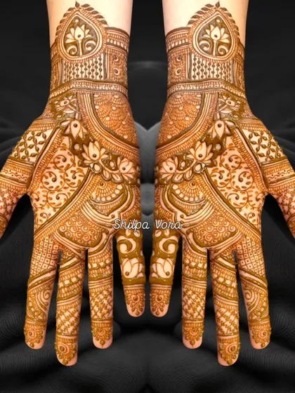 A stunningly detailed design with a heart motif at the wrist, perfect for an engagement or bridal look.