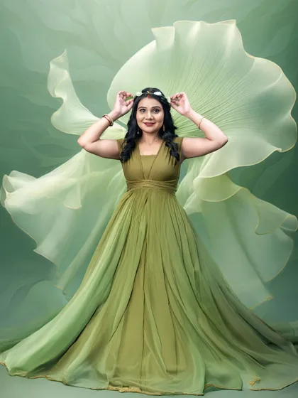 This lighter green gown has a beautiful, airy feel. Tossing the delicate fabric behind her creates a sense of weightlessness and fantasy in this studio maternity photo.