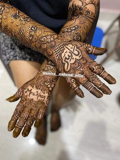 A lovely design with the name 'Mrs. Khan' written in English and a name in Arabic on the other palm.