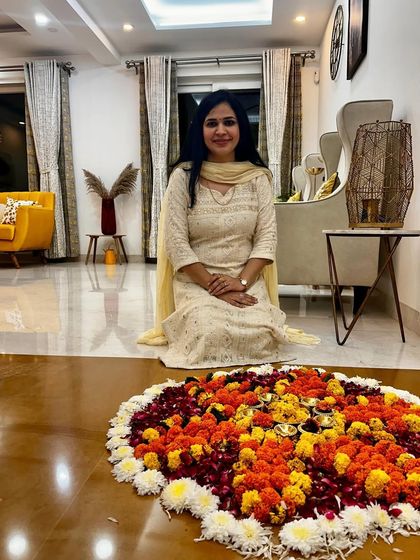 This white chikankari suit is perfect for a daytime festive event like a puja. Here I am, sitting next to a beautiful flower rangoli, feeling all the festive vibes.