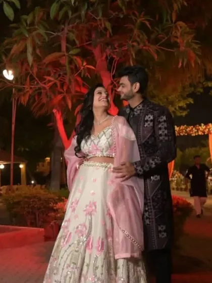 An evening function under the lights calls for an outfit that stands out. This couple chose a dark, intricately designed sherwani and a beautifully contrasting lehenga for their special moment.