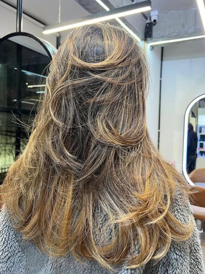 The layers in this cut work perfectly with the balayage highlights to create a full and dynamic style.
