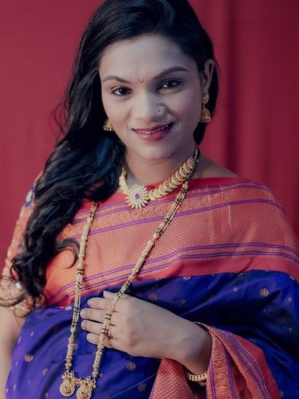 A close-up portrait of a happy mom-to-be, showcasing the detailed traditional jewellery and the rich colours of her saree. Full makeup and hairstyling are included in my packages.