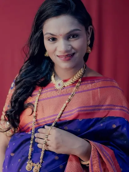 A close-up portrait of a happy mom-to-be, showcasing the detailed traditional jewellery and the rich colours of her saree. Full makeup and hairstyling are included in my packages.
