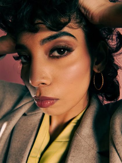 This shot uses a wide-angle lens up close to create a unique, distorted perspective that feels very modern and edgy. The "hot mess" theme is captured through the intense, in-your-face composition and the model's direct, unapologetic gaze.