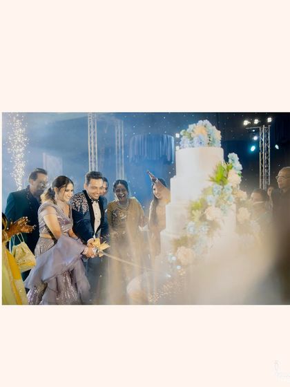 The cake-cutting ceremony at the Sangeet, complete with sparklers and happy faces. A moment of sweet celebration.