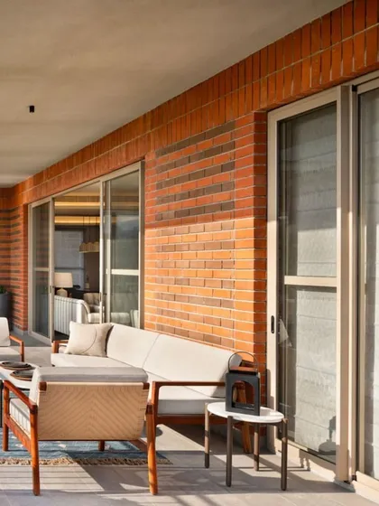 We love blurring the line between indoors and outdoors. This expansive deck at the Max128 apartment uses natural brick and comfortable outdoor furniture to create a true extension of the living space, perfect for enjoying a quiet morning or hosting friends.