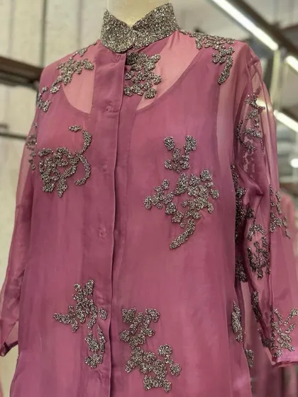 A sheer organza jacket in a deep mauve, featuring intricate silver floral embroidery, a beautiful layering piece from Peachoo.