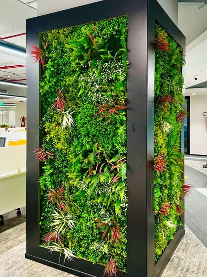 For this corporate office in Hyderabad, I designed and installed a multi-story artificial vertical garden. This green wall acts as a stunning visual centerpiece, improving the office aesthetic and bringing a sense of nature indoors without requiring maintenance like watering or sunlight.