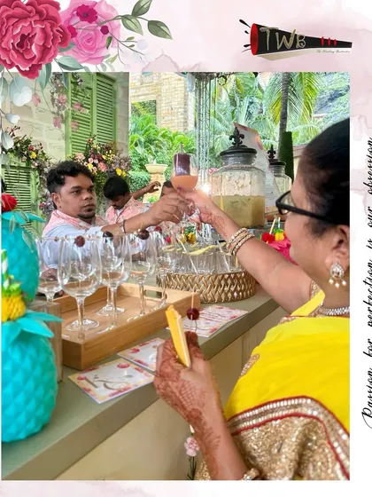A guest enjoys a freshly made cocktail at the Haldi ceremony, capturing a moment of joy.