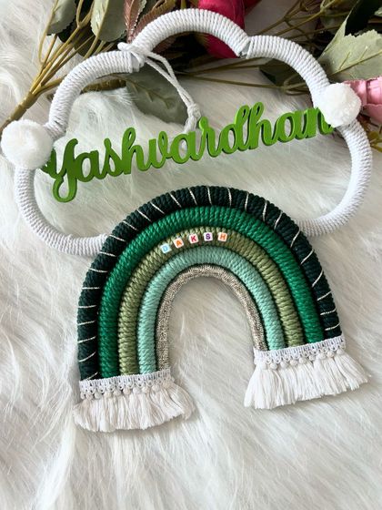 The "Yashwardhan" name hanging displayed on a soft, white background, showing off its vibrant green colors.