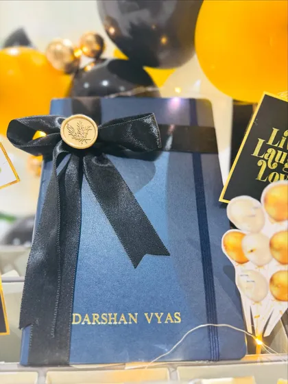 Personalization is at the heart of what we do. This close-up shows a custom diary with the recipient's name elegantly embossed in gold, turning a simple office essential into a meaningful and personal tool for success.