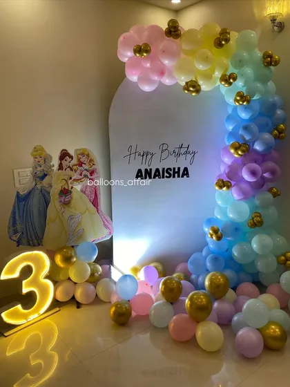 A full view of the pastel rainbow princess party setup, showing the arrangement in a home living room.