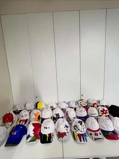 A colorful collection of hand-painted caps from my workshop with HBC. Each one is a small canvas showcasing big creativity.