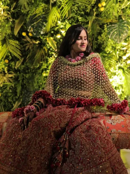 This is one of my most elegant floral dupattas, featuring a dense border of red rose petals. It creates a dramatic and royal look, perfect for a bride on her wedding day.