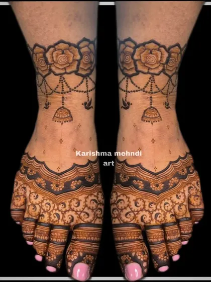 Mehendi for feet is an essential part of the celebration. This elegant design features a floral anklet band with delicate hanging jhumka motifs, perfect for any guest.
