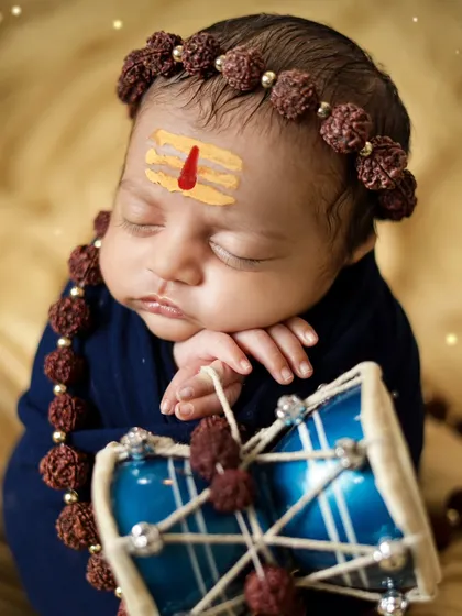 A close-up of the newborn Shiva, with a tripundra on his forehead. We handle every detail with care and respect for the theme.