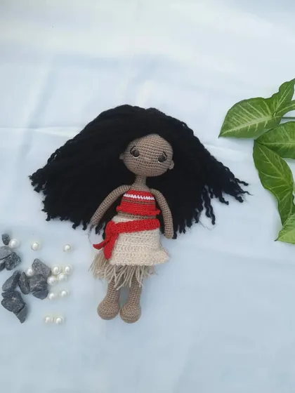 My handmade crochet version of Moana, with her signature curly black hair and traditional two-piece outfit.