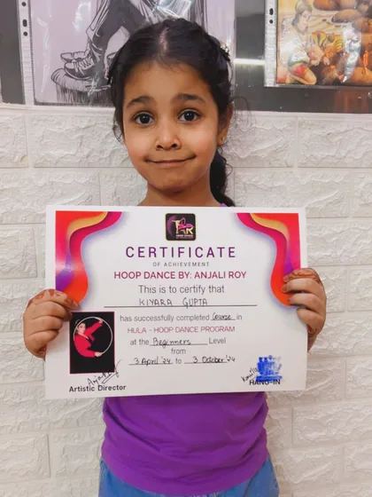 We congratulate this talented student on receiving her certificate for completing the beginner's course in our hula hoop dance program.