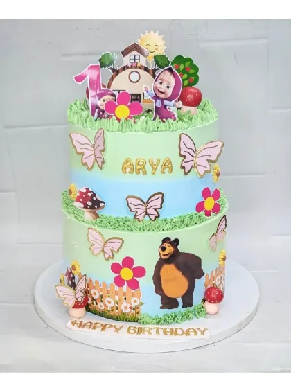A playful two-tier Masha and the Bear cake designed for a first birthday. This eggless fresh pineapple cake is decorated with butterflies and flowers, creating a cheerful woodland scene.