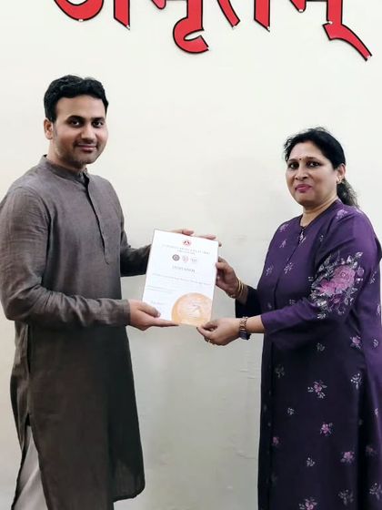 This student proudly receives her 200-hour YTTC certificate. We celebrate her commitment to personal growth and learning.