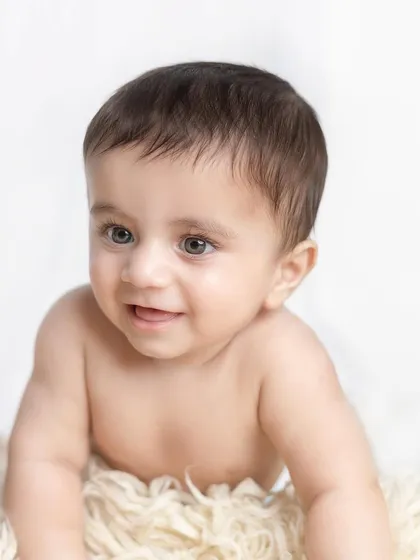 A close-up on a beautiful seven-month-old baby boy. His eyes are so expressive and engaging.