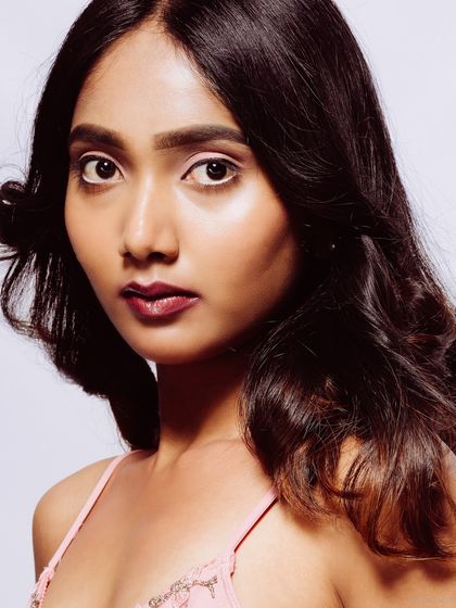 A close-up beauty shot with a serious and direct gaze.